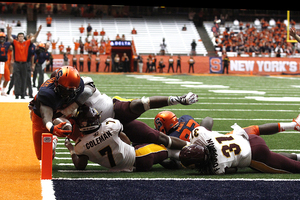 Jordan Fredericks reaches for the pylon in overtime to seal the 30-27 win for Syracuse.