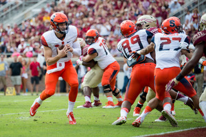 Eric Dungey looks to run with the ball. He scored twice for Syracuse on a pair of 1-yard runs, but had his lowest completion percentage of the season.
